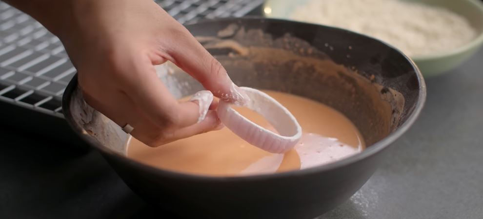 dipping onion ring in batter